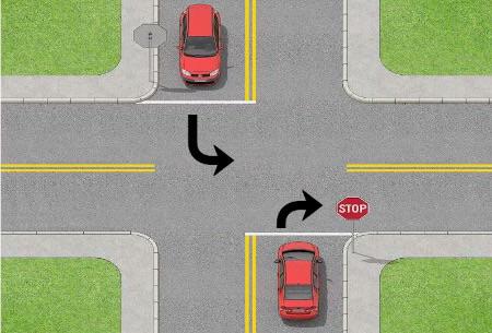 image of two vehicles turning at a two way stop