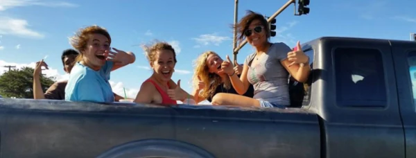 image of people riding in the back of a pickup truck