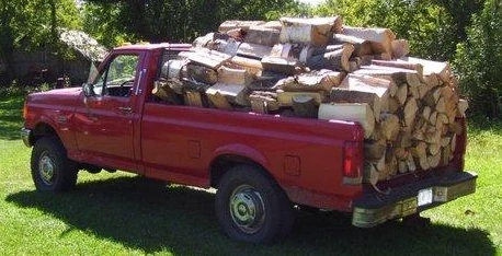 image of a pickup truck overloaded with firewood