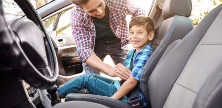 Buckled into the front seat without child restraint