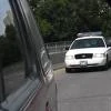 image of police car in rear view mirror