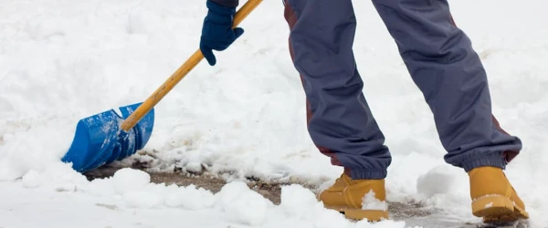 image of a person shovelling the sidewalk