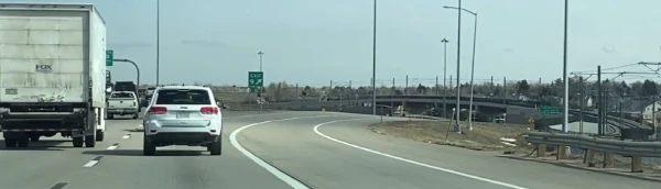 image of a car beside a single solid line on the highway
